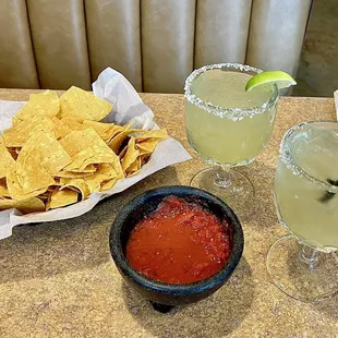 a bowl of chips and a bowl of salsa