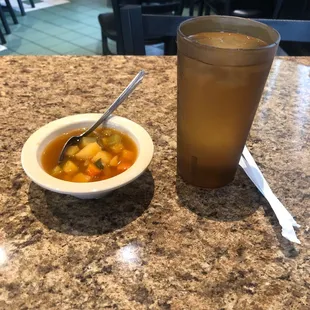 Soup and water , warm welcoming c:  And by the way,  I have a michelada on its way c;