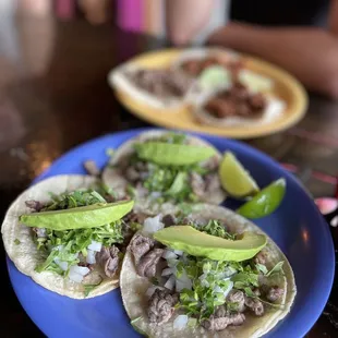 three tacos on a blue plate