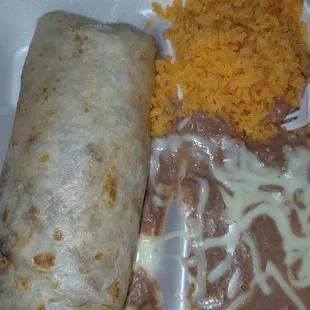 Steak burrito with rice and beans.