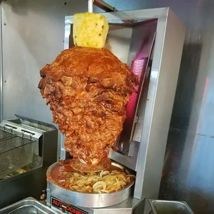 a large piece of meat being cooked