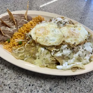delicious chilaquiles with egg served with rice and  beans