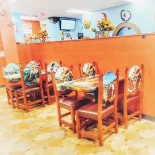 a dining area with orange walls