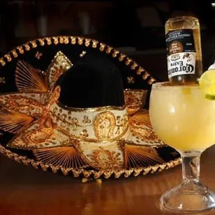 a glass of tequila and a sombren