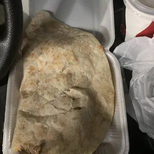 a burrito in a styrofoam container