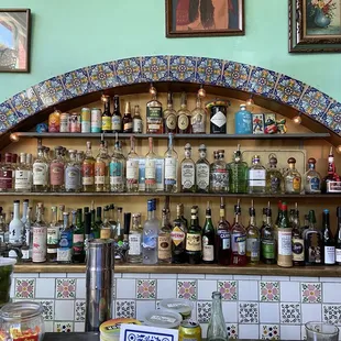 a bar with many bottles of alcohol