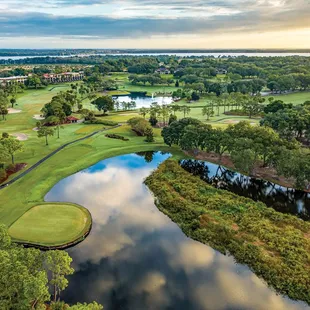 a view of a golf course with a lake in the foreground