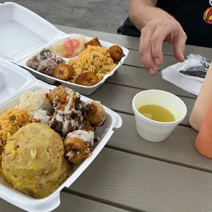 Both of our meals along with the dipping broth for the Mofongos and the two side sauces.  The portion sizes were epic!