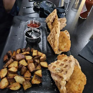 a plate of fried potatoes and waffles
