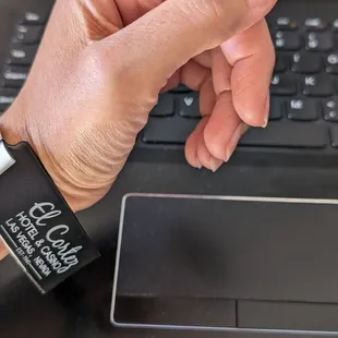 Prisoner-style bracelet that also announces to the whole world where you're staying.