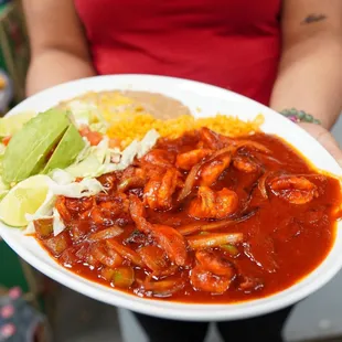 a person holding a plate of food