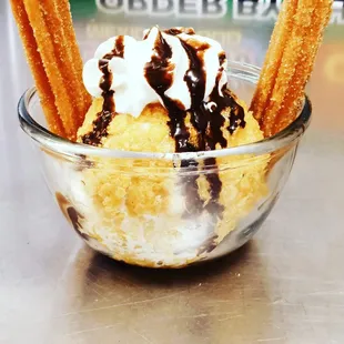 a bowl of ice cream and churros