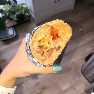 a person holding a burrito