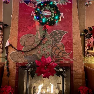 a fireplace decorated for christmas