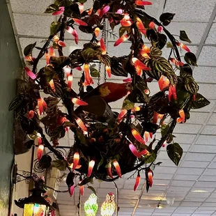 a circular chandelier with flowers and birds