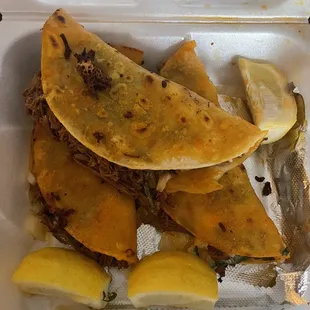 Birria Tacos. So good dipped in the red and green sauce!