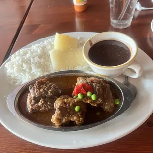 Oxtail , Black beans , rice and garlic yuka.