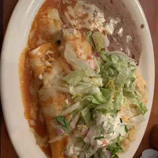 Combination platter #14 Chicken and Beef burritos with rice and beans.