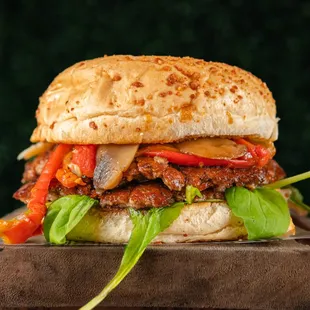 a meat sandwich on a wooden cutting board