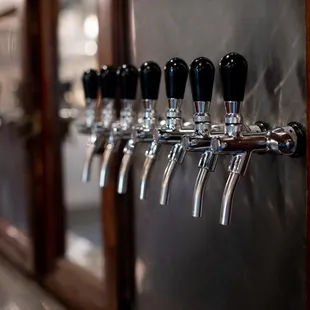 a row of beer taps