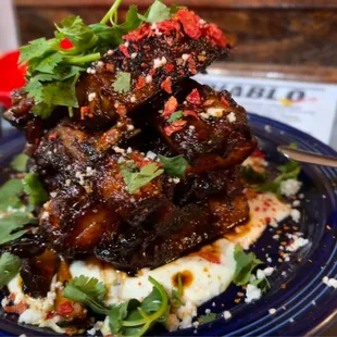 Ribs Special over avacado ranch with special glaze and hot takis.  Fall off the bone Melt in your mouth delicious.
