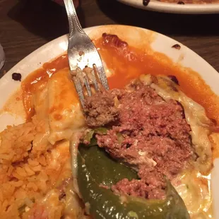 My chile relleno had undercooked meat in it (the meat on the fork is cooked meat from another dish for comparison).