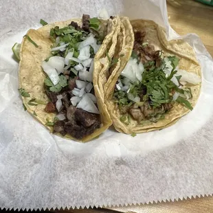 Tacos: carne asada (left) and carnitas (right) with onions and cilantro
