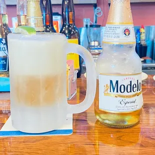 a pitcher of beer and a bottle of modelo