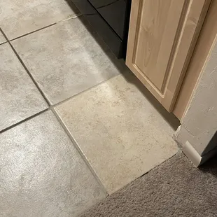 Tile replacement due to damage from previous tenants.