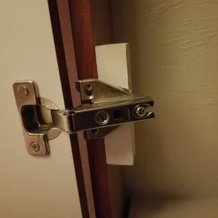 Unattached hinge (Found in kitchen and linen closet)