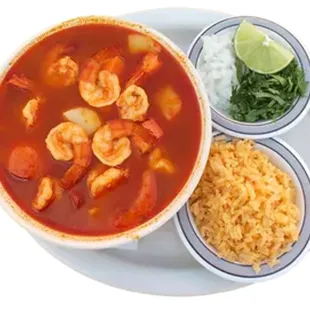 a bowl of soup with shrimp and rice