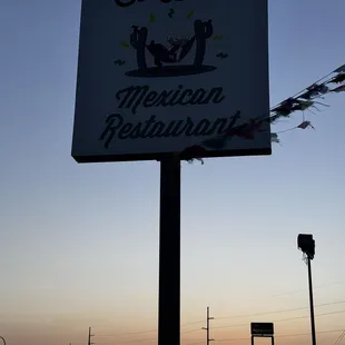 Sign behind the gas station to help you find the restaurant