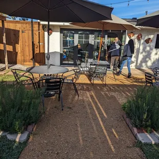 a patio with tables and umbrellas