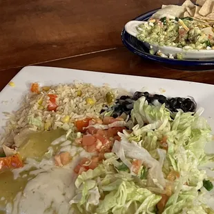 Vegetarian Enchiladas with extra lettuce/tomato garnish as requested and guacamole/chips in background