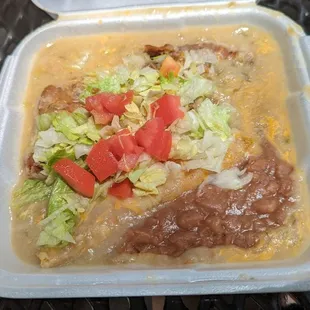 Combination with chili relleno, cheese enchilada, and beans covered in green chili sauce.