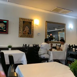 two people sitting at a table in a restaurant