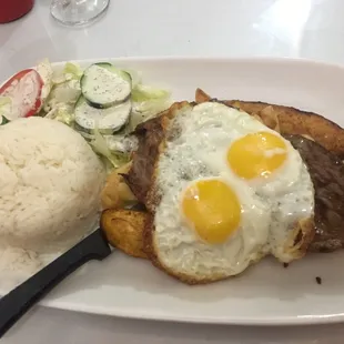 Bistec a la Limena, steak with fried egg, salad, fried plantain &amp; fries