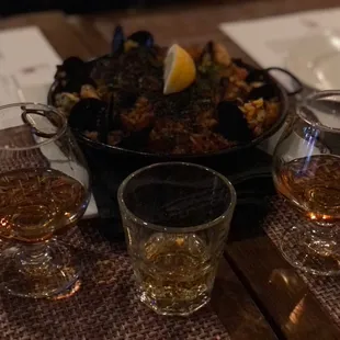 a bowl of food and glasses of wine