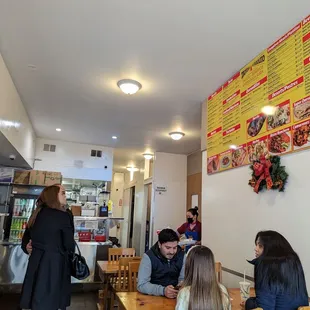 people sitting at tables in a restaurant