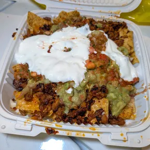 super al pastor (marinated pork) nachos $12.65