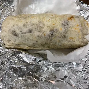 a burrito wrapped in aluminum foil