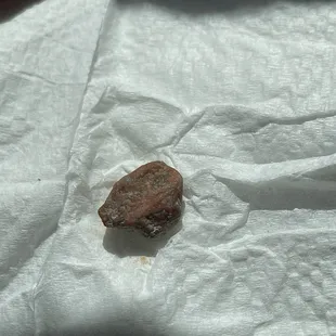 a rock on a piece of paper