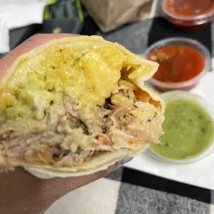 a person holding a burrito