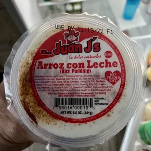 a person holding a container of ice cream