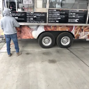 a man standing in front of a food truck