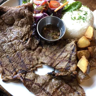 Steak and salad with potatoes and white rice