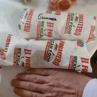 Bean and cheese burrito in front, Cali burrito in back hand so you can see size