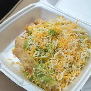 Five rolled tacos with guacamole and cheese