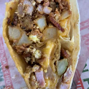 Super breakfast burrito. Perfect distribution of ham, chorizo, bacon, potato, egg and cheese in EVERY bite. Delicious