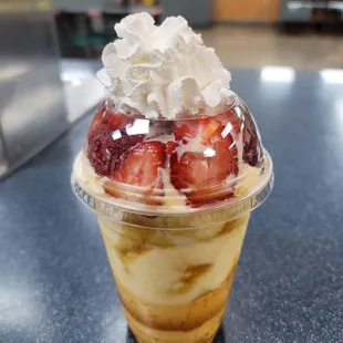 an ice cream sundae with strawberries and whipped cream